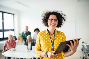 Teacher holding a tablet in the classroom